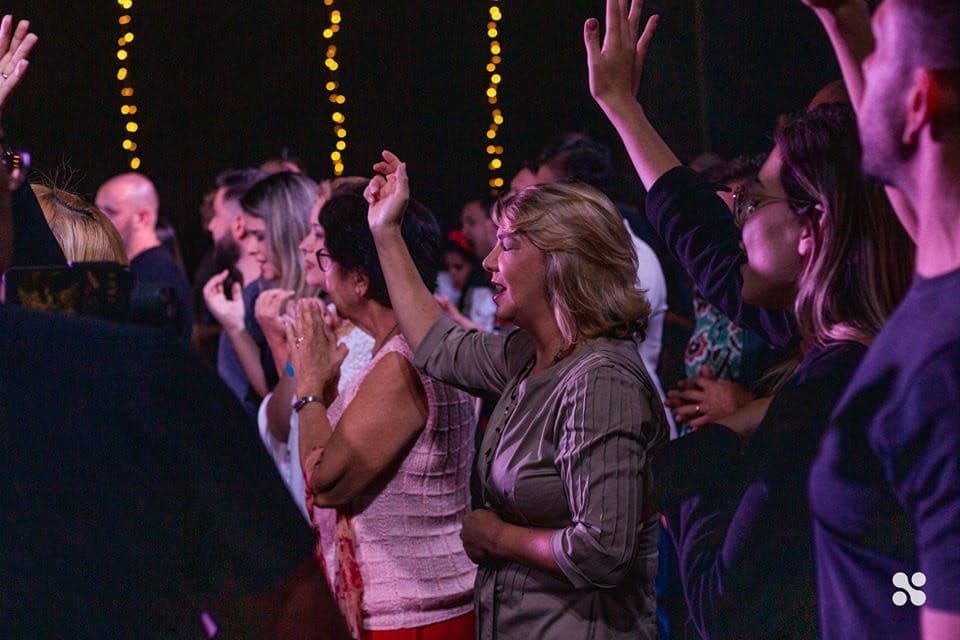 Women worshipping with their hands raised